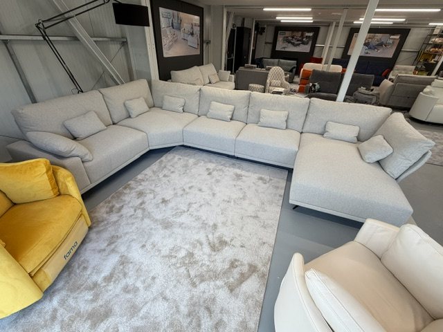 Fama Oasis corner sofa with seven lumbar cushions and an arm cushion