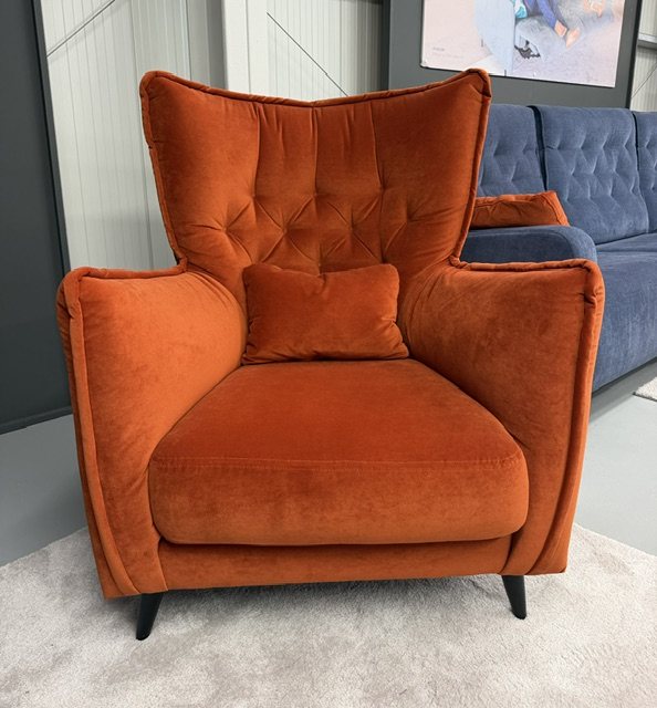 Fama Simone K aqua velvet armchair styled in a contemporary living space