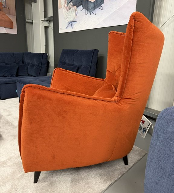 Side view of the Fama Simone K wingback armchair in Varenna 62 velvet