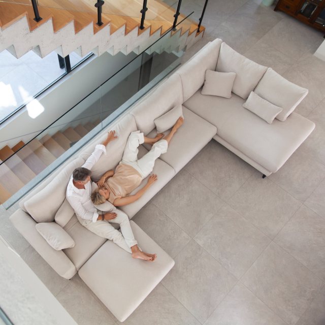 Side view of the Fama Scala corner sofa showing its contemporary design and raised legs